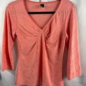 Size Medium Peach V Neck 3/4 sleeve top with stitching details.